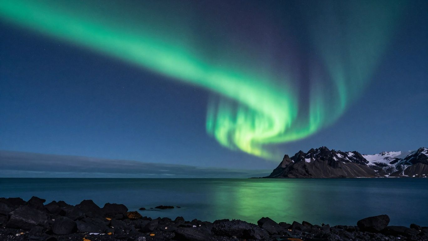 Northern lights above a dark Icelandic coast